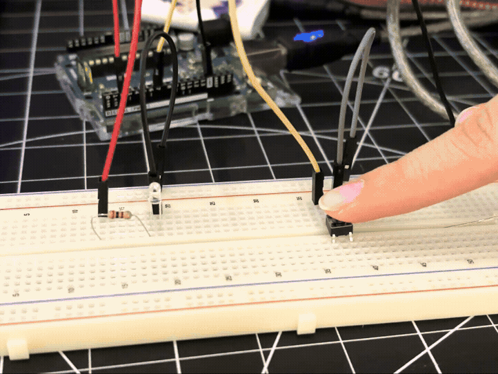 <b>Using a button</b><br>Using a different code provided to us in class, this sketch allows the user to push a button to turn on the LED. This type of button allows the user to press and hold it to keep the LED on for a set duration.