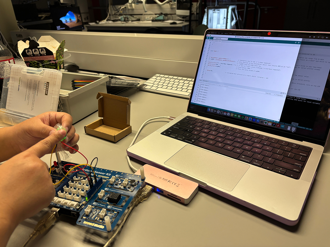 Testing another peer’s Pulse Sensor, making sure that it is covered with a cling wrap to protect it